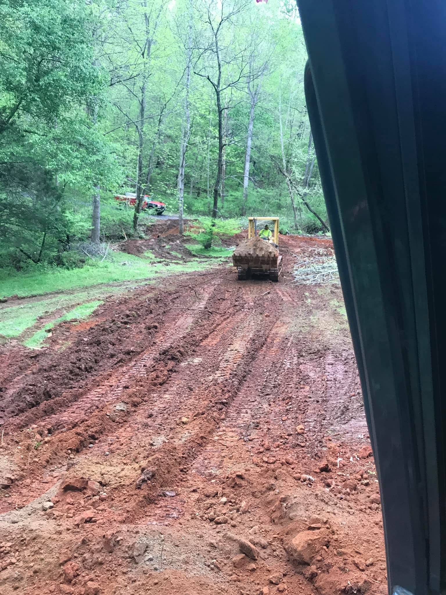 Dozer grading a cleared road bed